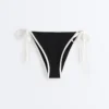 Culottes de bikini à couverture moyenne avec bordures contrastées et liens