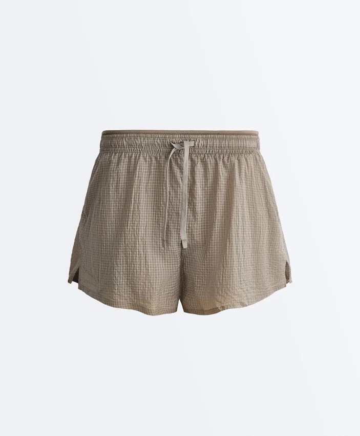 Short technique 2-en-1 à carreaux et taille mi-haute Short technique 2-en-1 à carreaux et taille mi-haute