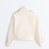 Veste en coton piqué avec bande à chevrons sur les côtés Veste en coton piqué avec bande à chevrons sur les côtés
