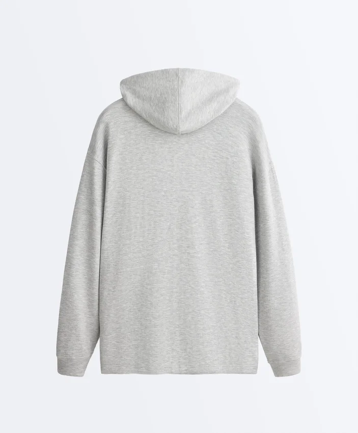 Veste longue à capuche en piqué chiné Veste longue à capuche en piqué chiné